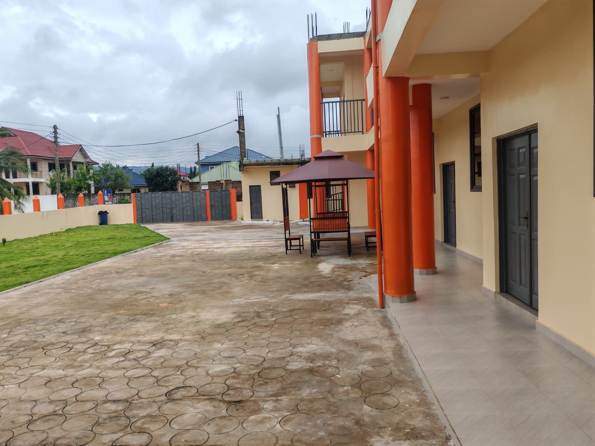 SLIS campus courtyard with covered walkway, gazebo seating and the front gate